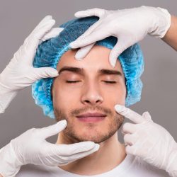 doctor-39-s-hands-in-gloves-checking-face-of-young-man.jpg